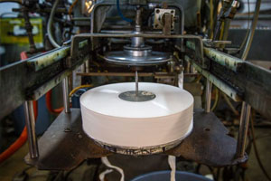Stack of white records on a machine