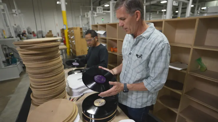 Mark Michaels with United Record Pressing worker holding 12" record