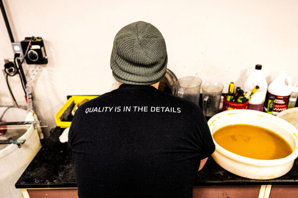 Plating employee cleaning metal parts