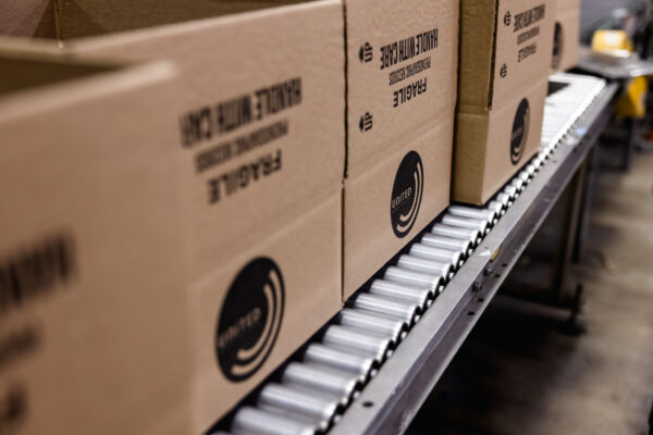 Vinyl record shipping boxes on shrink wrap line