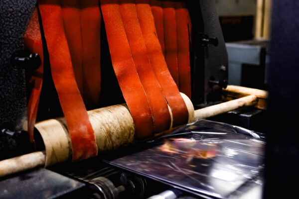 Vinyl records moving through shrink wrap line