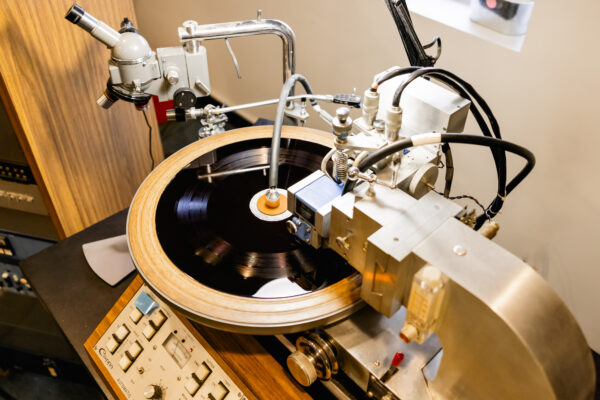 Overhead shot of a lacquer disc being cut on a lathe