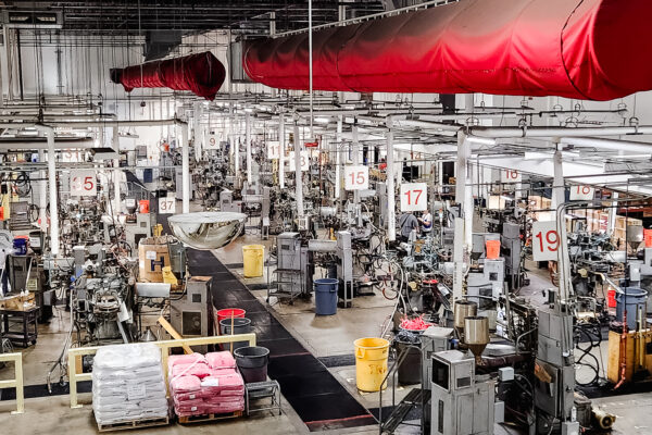 Vinyl record manufacturing floor with presses and workers