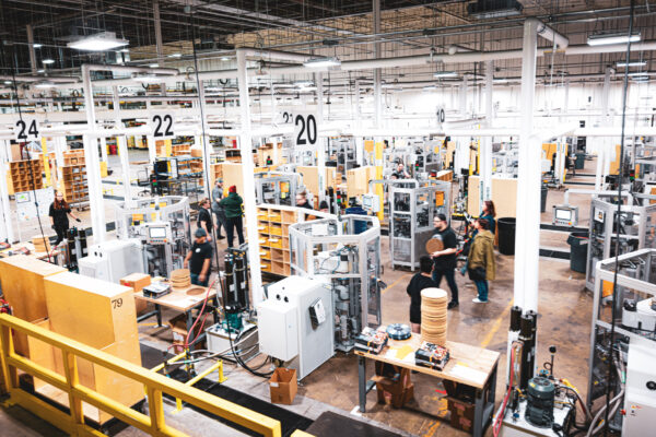 Vinyl record manufacturing floor with presses and employees working