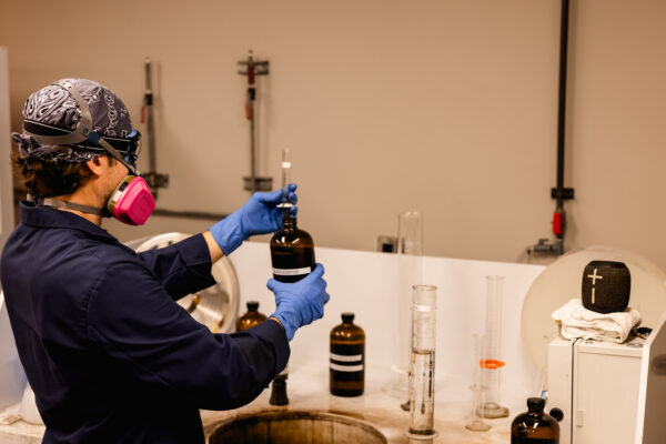 Worker in PPE mixing chemicals