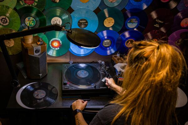 Overhead shot of worker playing vinyl record in an office