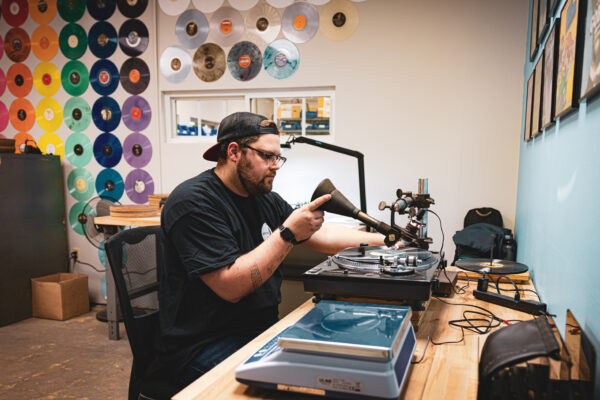 Employee sitting at a table with turntable