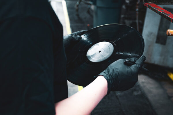 Worker holding pressed vinyl record