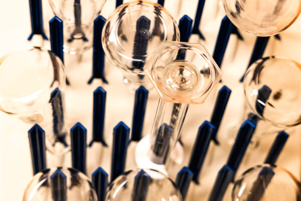 Glass beakers in a drying rack