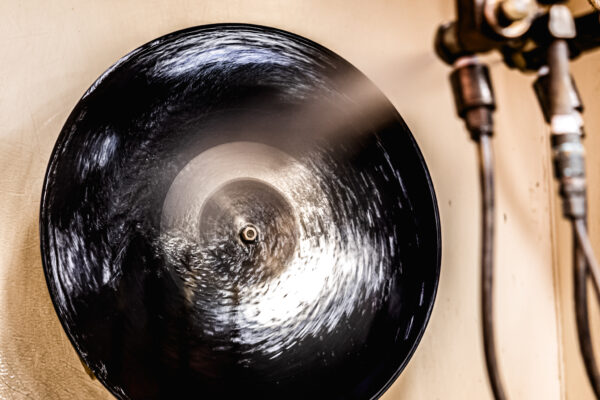 Lacquer disc being sprayed with silver during the silvering process