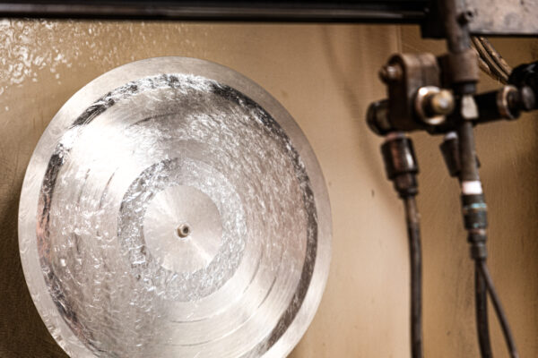 Lacquer disc getting sprayed with silver during the silvering process