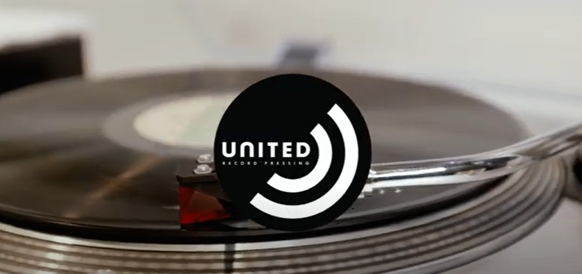 Photo of record on a turntable with URP logo